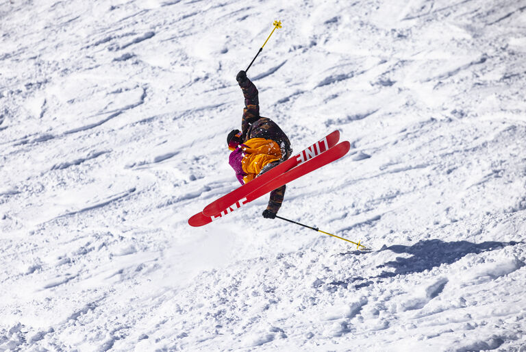 skiier jumping on line skis with a red base
